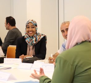 TMT Shiraka Water Management_2021_CR_P_Woman and Man laughing with fellow participant_Women_Men_MENA